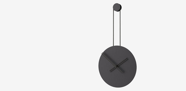 Black wall clock with a minimalist design and hanging mechanism, featured in the Black Wall Clocks collection.